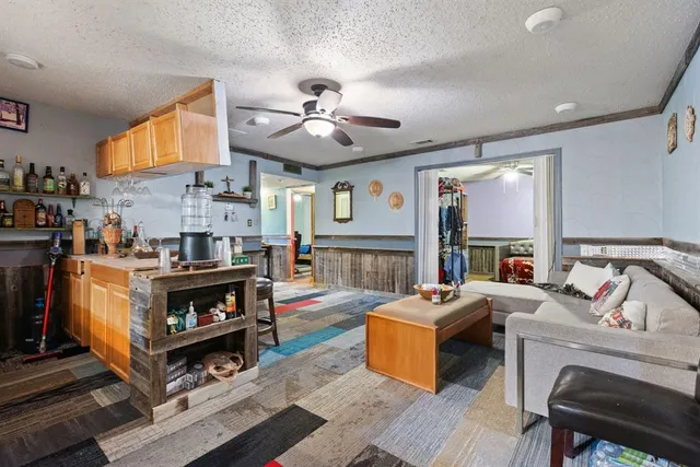 a living room with fireplace furniture and a large window