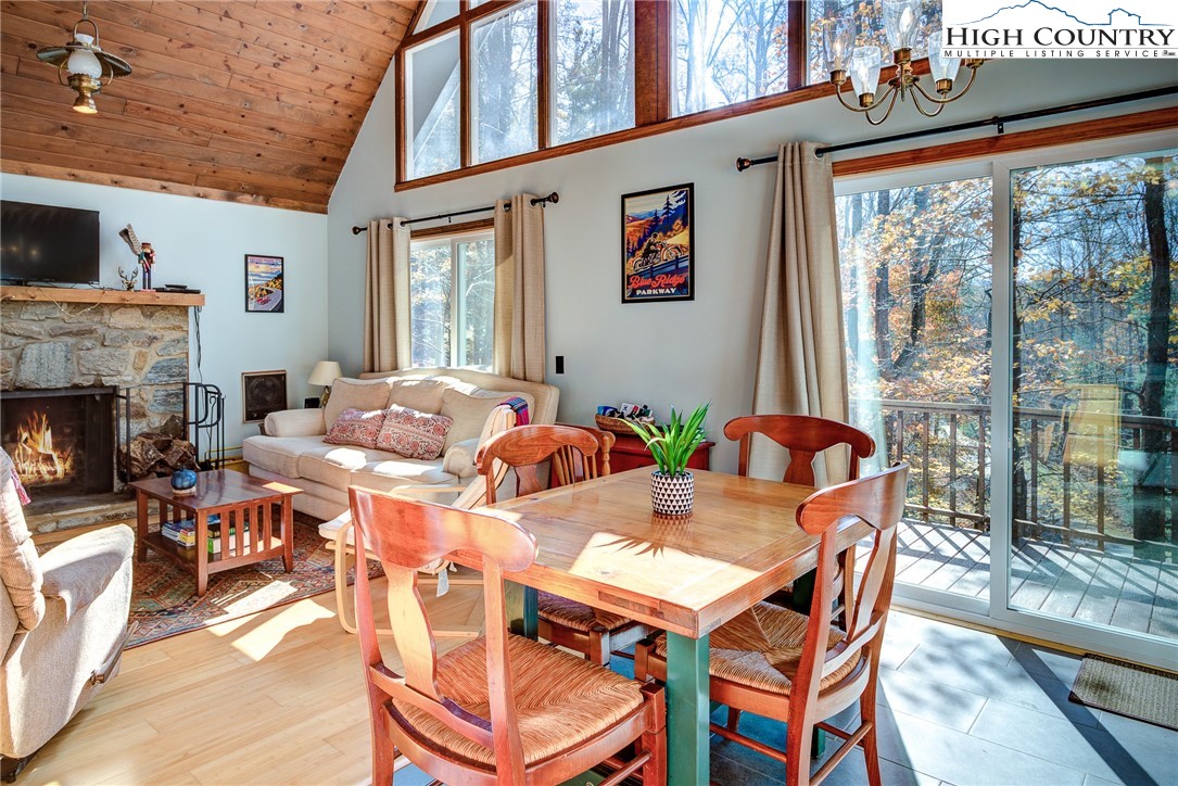 2143 Powder Horn Mountain Road Deep Gap, NC 28618 - Photo 20 of 37 a view of a dining room with furniture window and outside view
