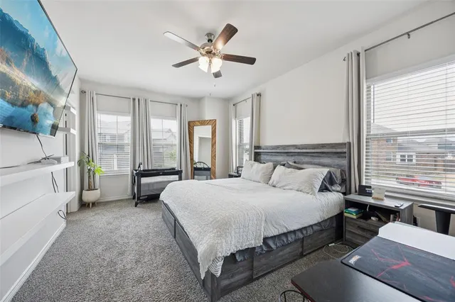 a spacious bedroom with a bed and a large window