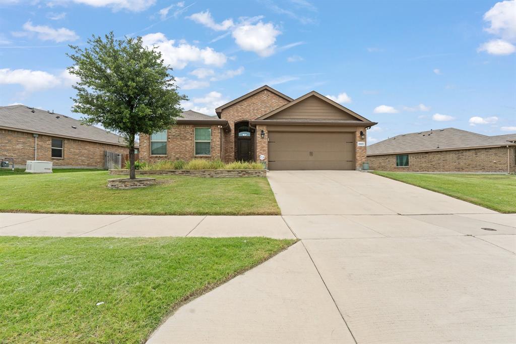 4600 Fringetree Way Crowley, TX 76036 - Photo 2 of 40 Brick facade residence featuring a two-car garage, mature front yard tree, and an inviting entry