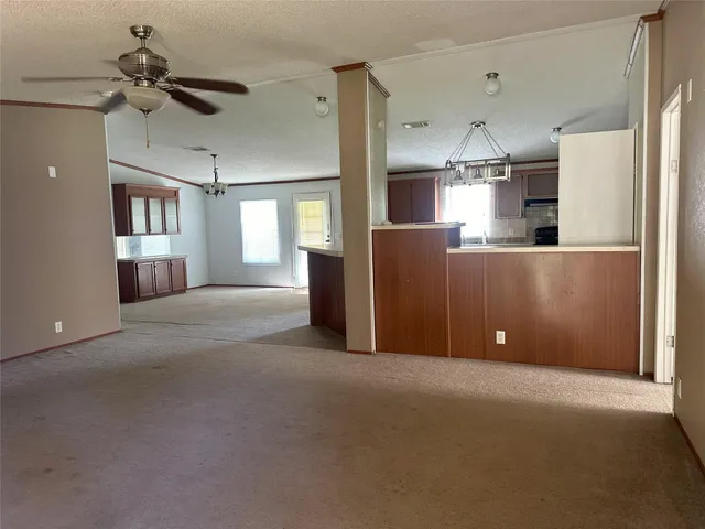 a view of a livingroom with a ceiling fan and window