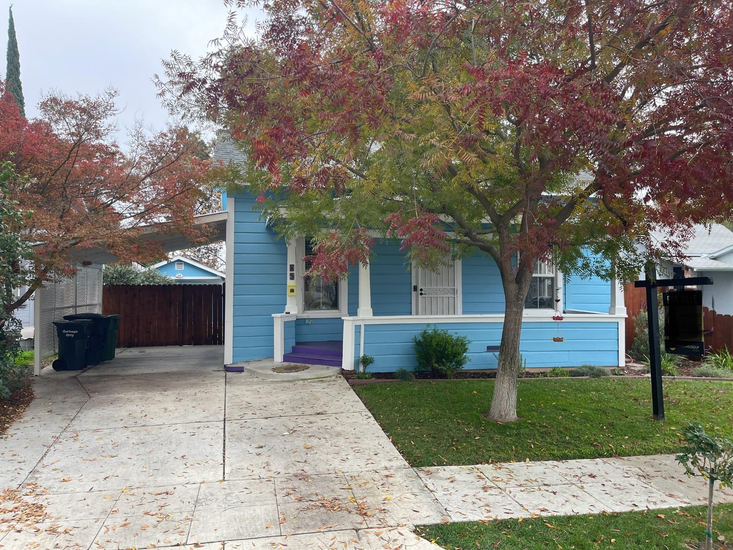 a front view of a house with a yard and trees