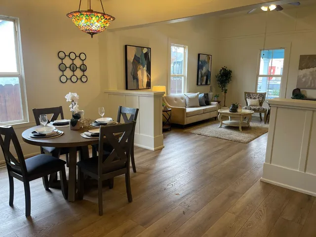 a view of a dining room with furniture and wooden floor