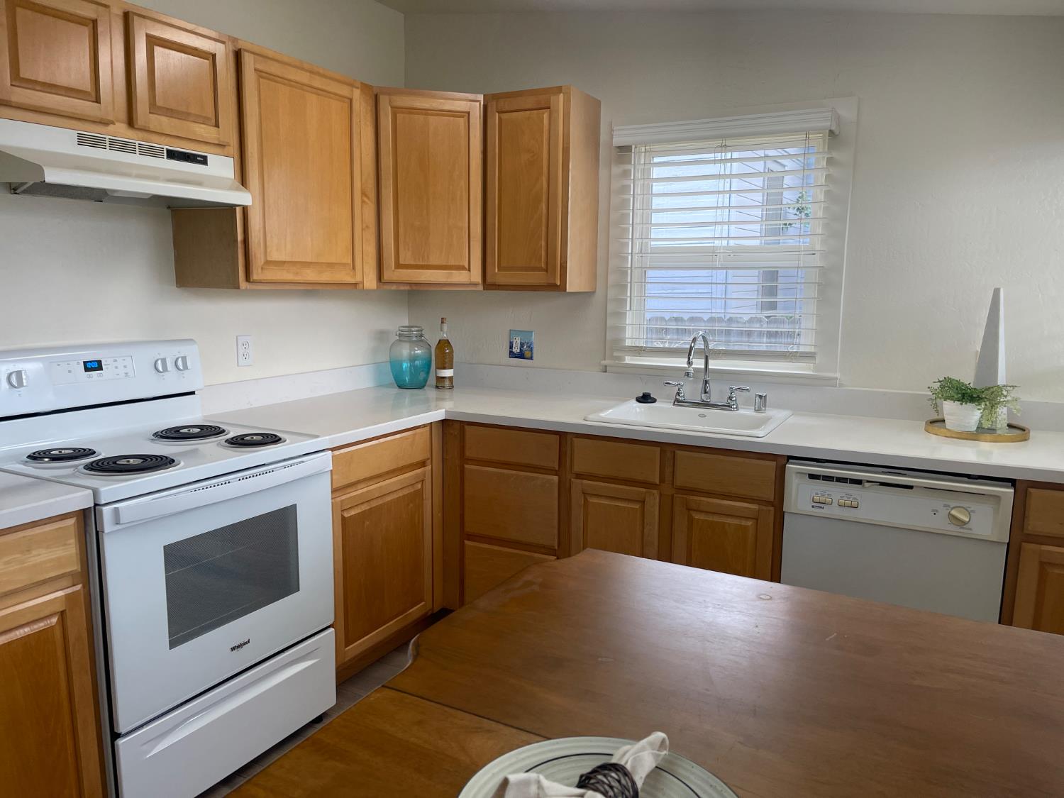 85 West 8th Street Tracy, CA 95376 - Photo 15 of 27 a kitchen with stainless steel appliances white cabinets granite counter tops and a window