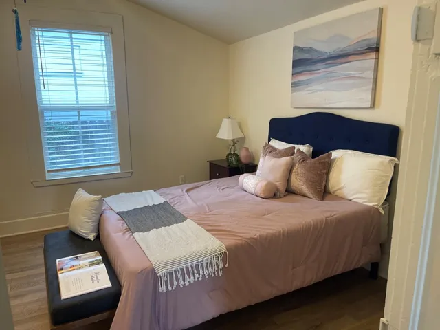 a bedroom with bed and window