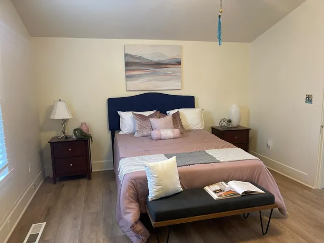 a bed sitting in a bedroom next to a window