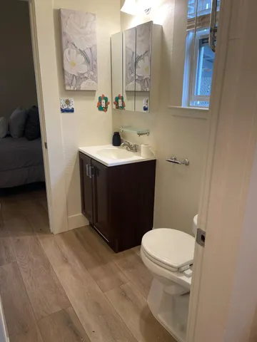 a bathroom with a toilet sink and mirror