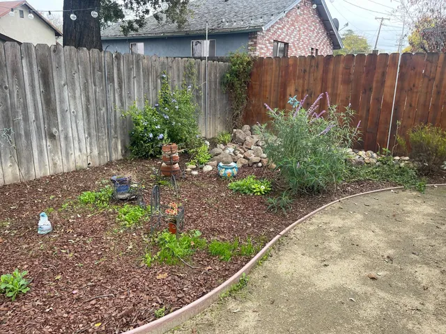 a backyard of a house with table and chairs
