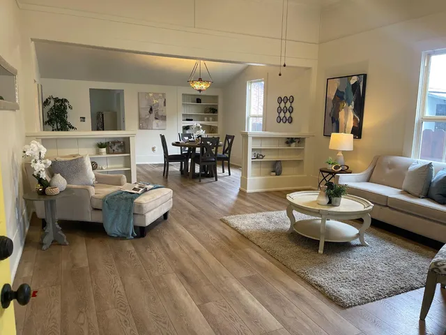 a living room with furniture and wooden floor