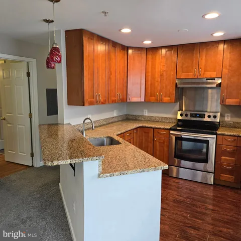 a kitchen with stainless steel appliances a refrigerator a stove a sink and a microwave