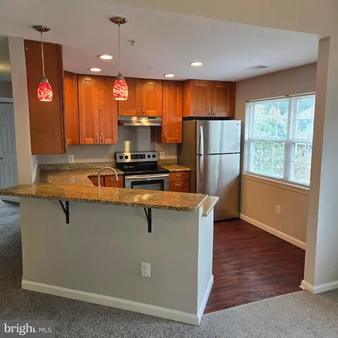 a kitchen with stainless steel appliances granite countertop a sink and a microwave