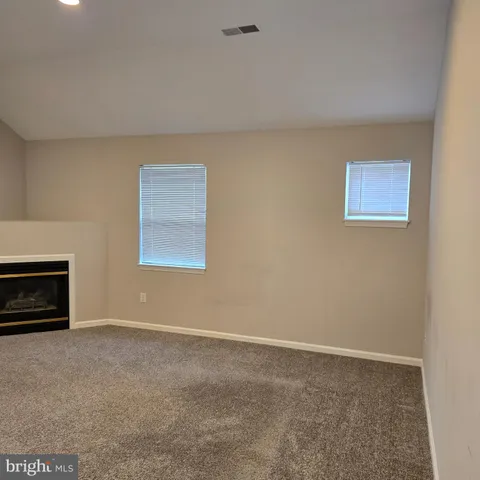 a view of an empty room with a fireplace