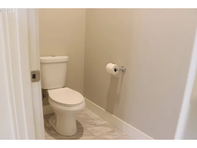 a bathroom with a white toilet and a shower