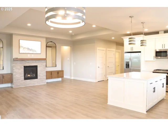 a view of a kitchen with a sink and a fireplace