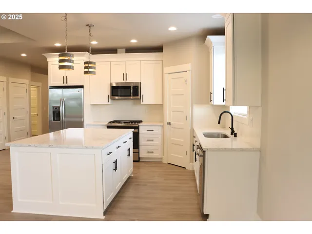 a kitchen with a sink a stove and a refrigerator