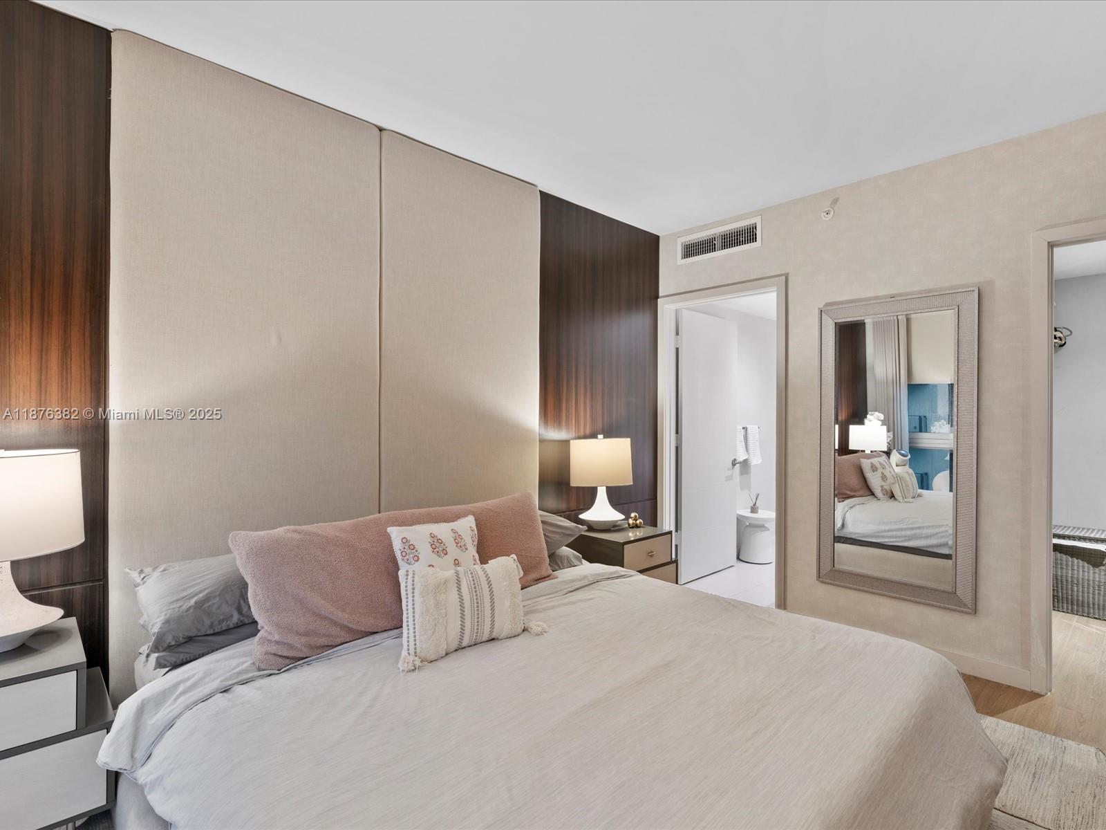 1010 Southwest 2nd Avenue, Unit 1908 Miami, FL 33130 - Photo 12 of 49 a bedroom with a bed and a mirror