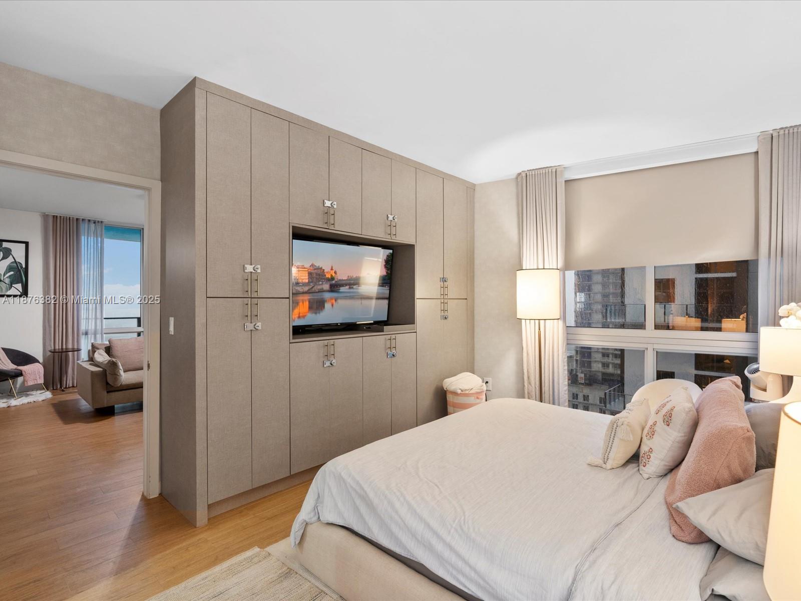 1010 Southwest 2nd Avenue, Unit 1908 Miami, FL 33130 - Photo 13 of 49 a bedroom with a bed and wooden floor