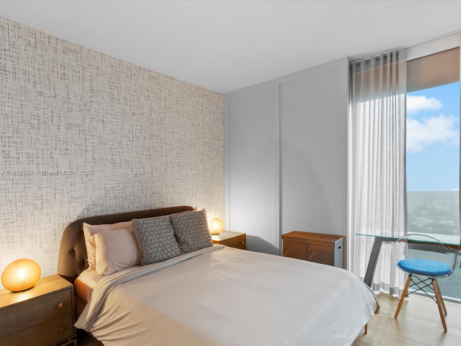 1010 Southwest 2nd Avenue, Unit 1908 Miami, FL 33130 - Photo 22 of 49 a bedroom with a bed and a chair