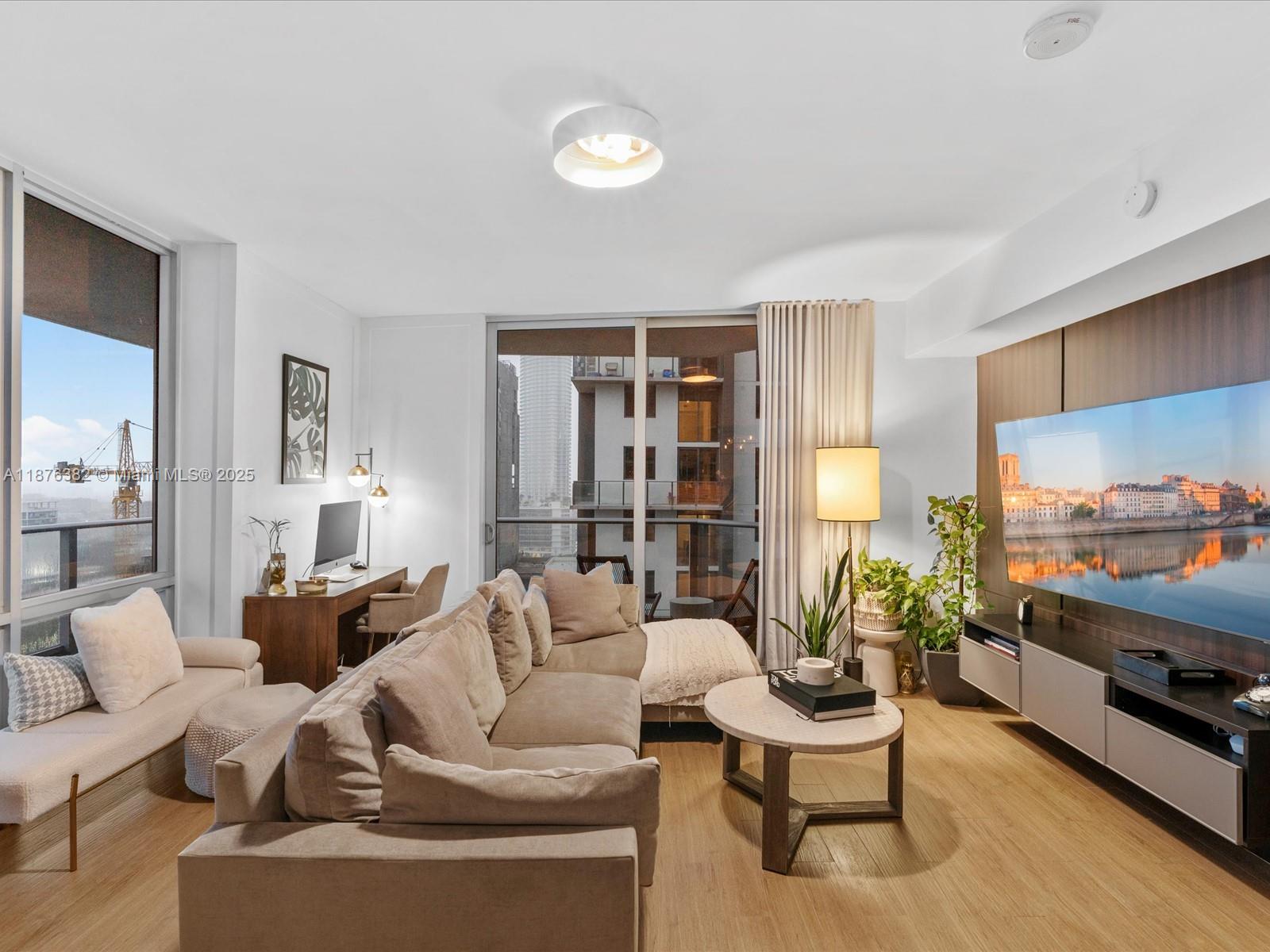 1010 Southwest 2nd Avenue, Unit 1908 Miami, FL 33130 - Photo 3 of 49 a living room with furniture and a flat screen tv