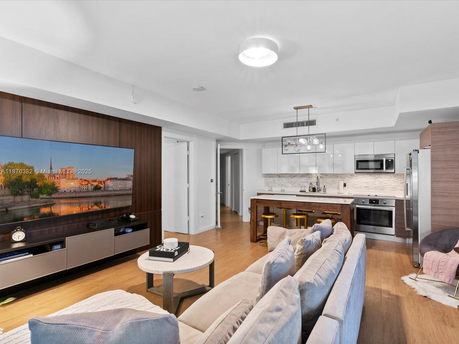 1010 Southwest 2nd Avenue, Unit 1908 Miami, FL 33130 - Photo 4 of 49 a living room with stainless steel appliances kitchen island granite countertop furniture and a kitchen view