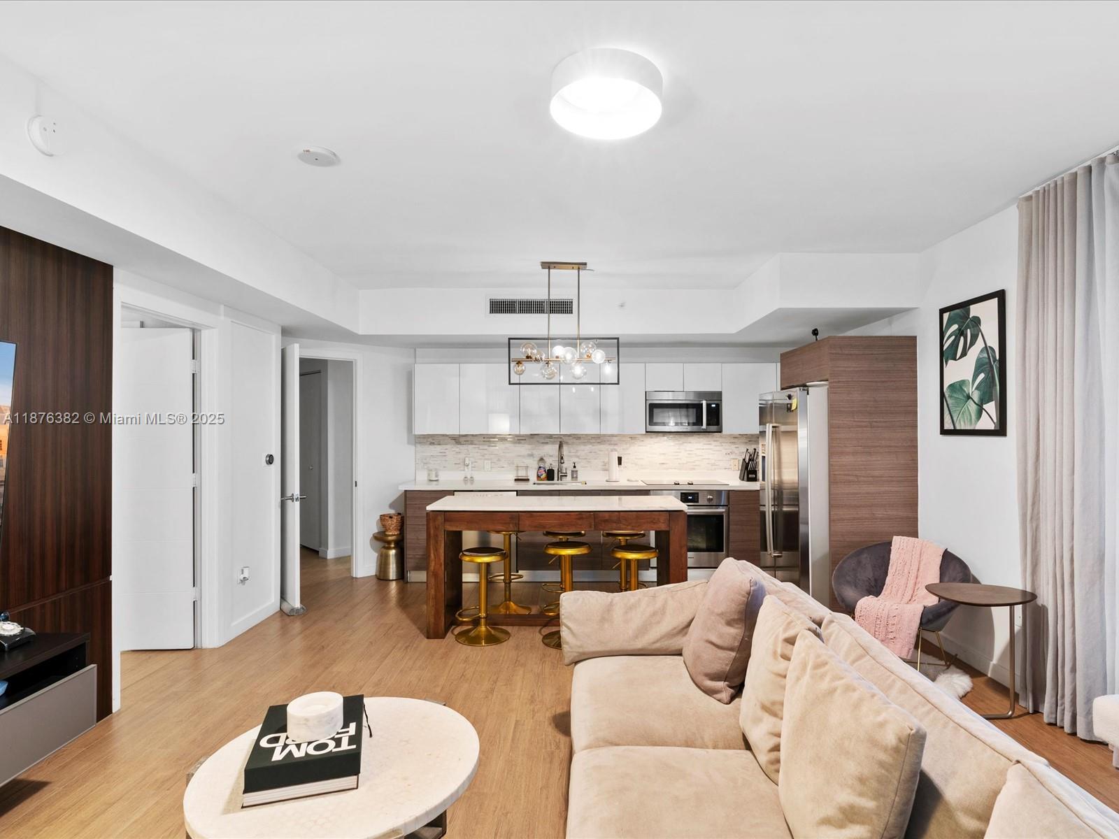 1010 Southwest 2nd Avenue, Unit 1908 Miami, FL 33130 - Photo 10 of 49 a living room with furniture and a dining table