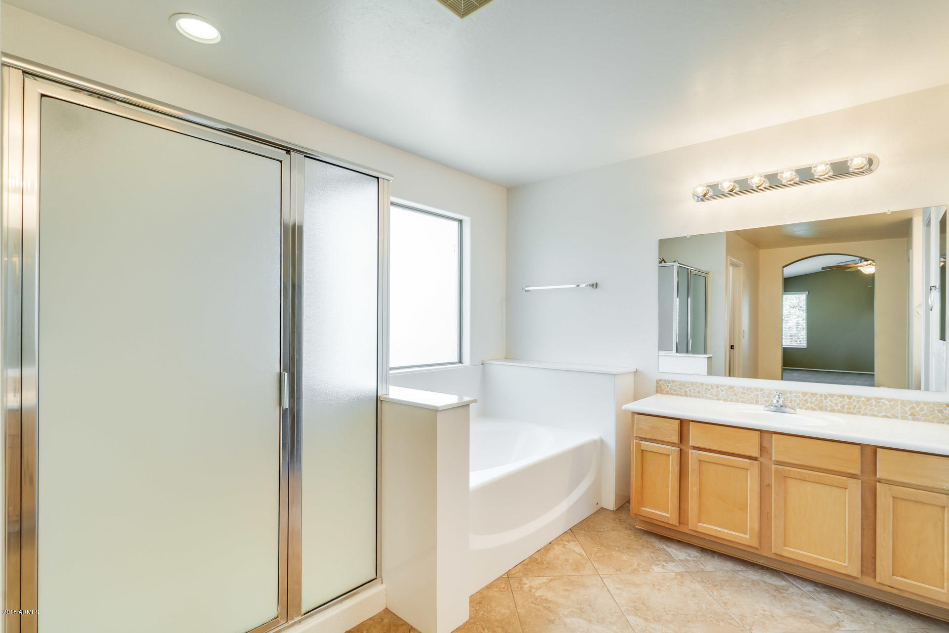 3250 East Blue Ridge Way Gilbert, AZ 85298 - Photo 33 of 44 a spacious bathroom with a tub shower and mirror