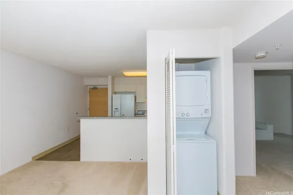 a view of a kitchen with a sink and a refrigerator