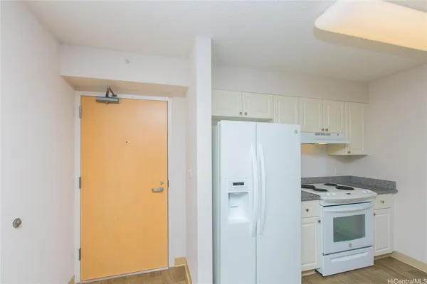 a kitchen with stainless steel appliances white cabinets and a refrigerator