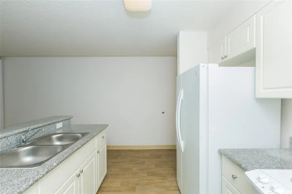 a bathroom with a granite countertop sink and vanity
