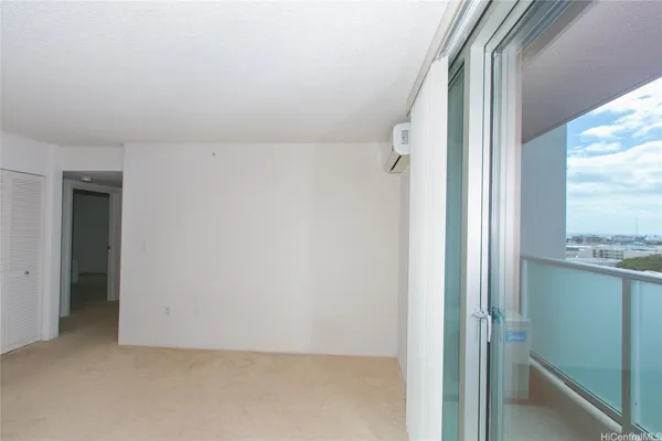 an empty room with a fireplace and cabinet