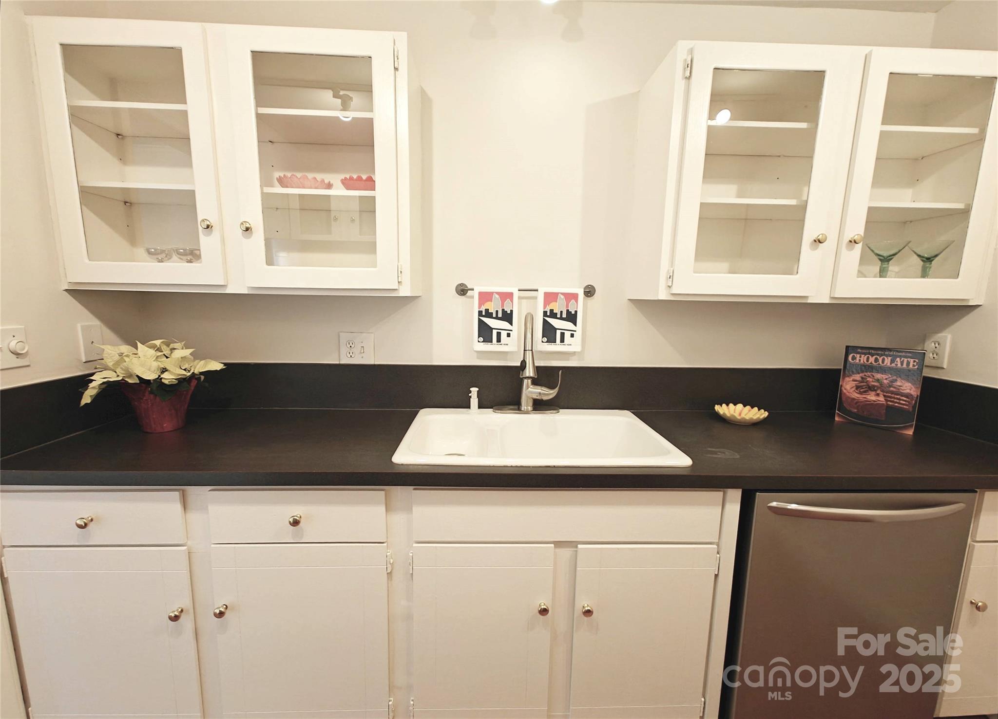 1323 Queens Road, Unit 321 Charlotte, NC 28207 - Photo 1 of 30 a kitchen with a sink and a window