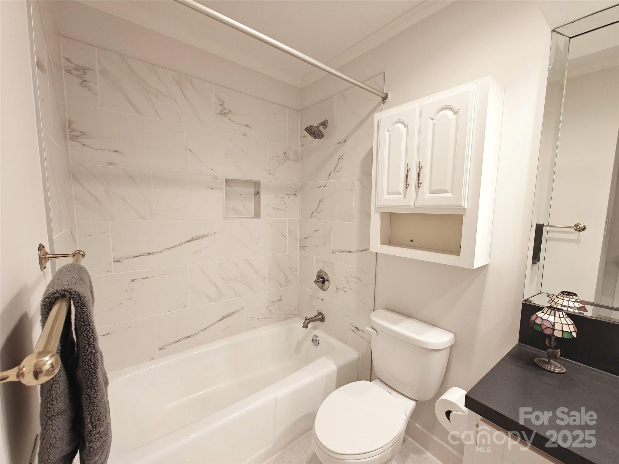 1323 Queens Road, Unit 321 Charlotte, NC 28207 - Photo 13 of 30 a bathroom with a toilet a sink and bathtub