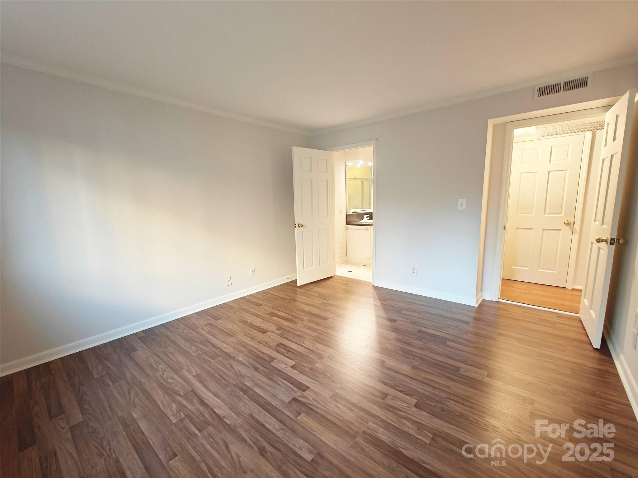 1323 Queens Road, Unit 321 Charlotte, NC 28207 - Photo 17 of 30 a view of empty room with wooden floor and fan