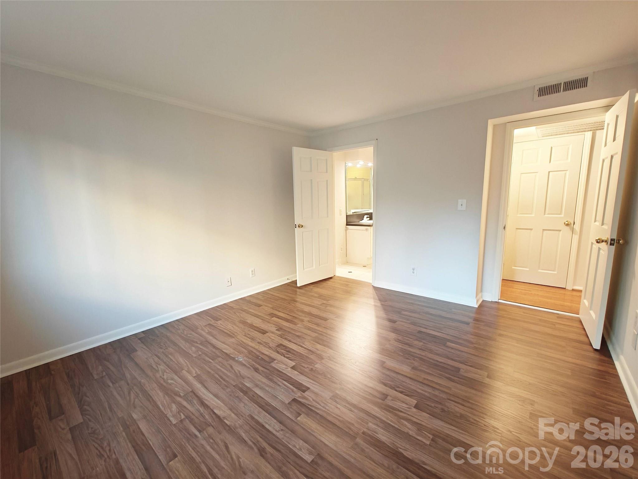 1323 Queens Road, Unit 321 Charlotte, NC 28207 - Photo 17 of 31 a view of empty room with wooden floor and fan