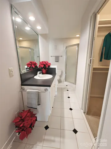a bathroom with a glass door shower and toilet