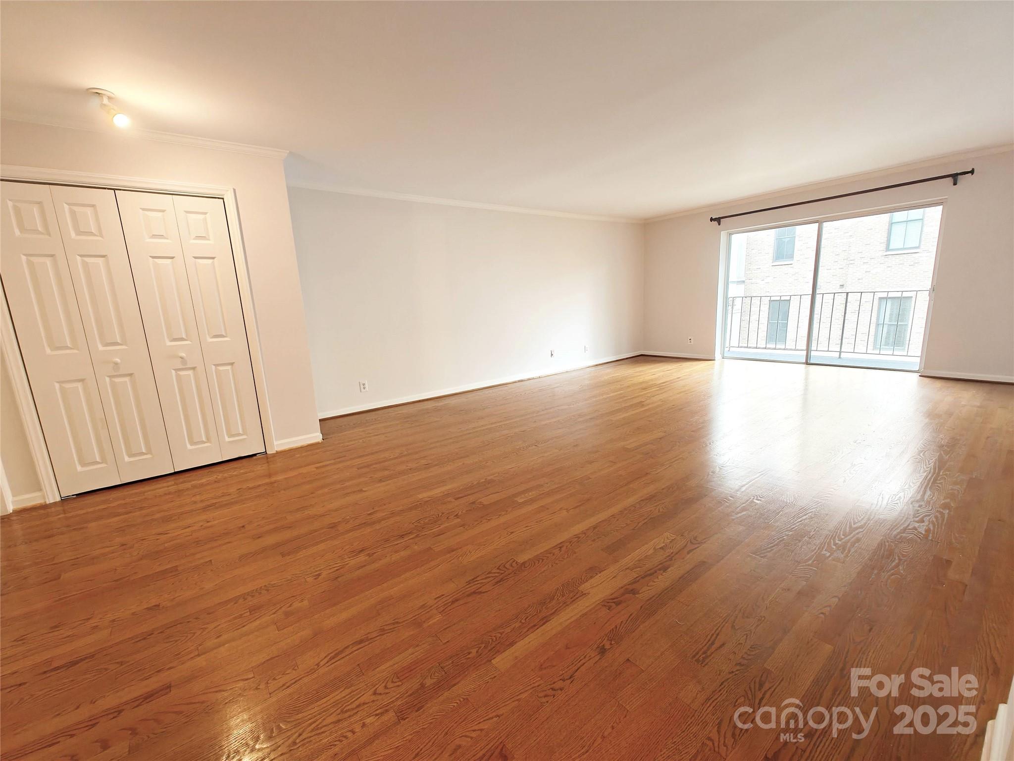 1323 Queens Road, Unit 321 Charlotte, NC 28207 - Photo 2 of 30 an empty room with wooden floor and windows