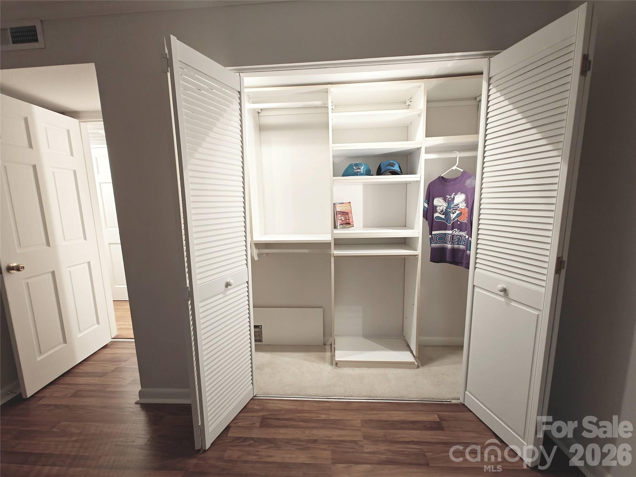 1323 Queens Road, Unit 321 Charlotte, NC 28207 - Photo 25 of 31 a room with window and wooden floor