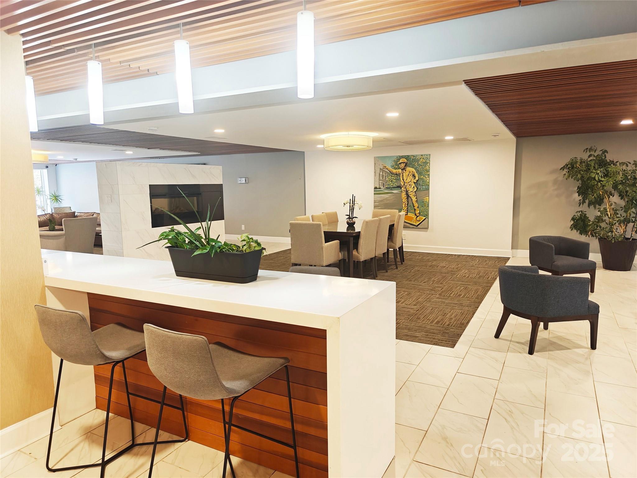 1323 Queens Road, Unit 321 Charlotte, NC 28207 - Photo 26 of 30 a kitchen with a table and chairs in it