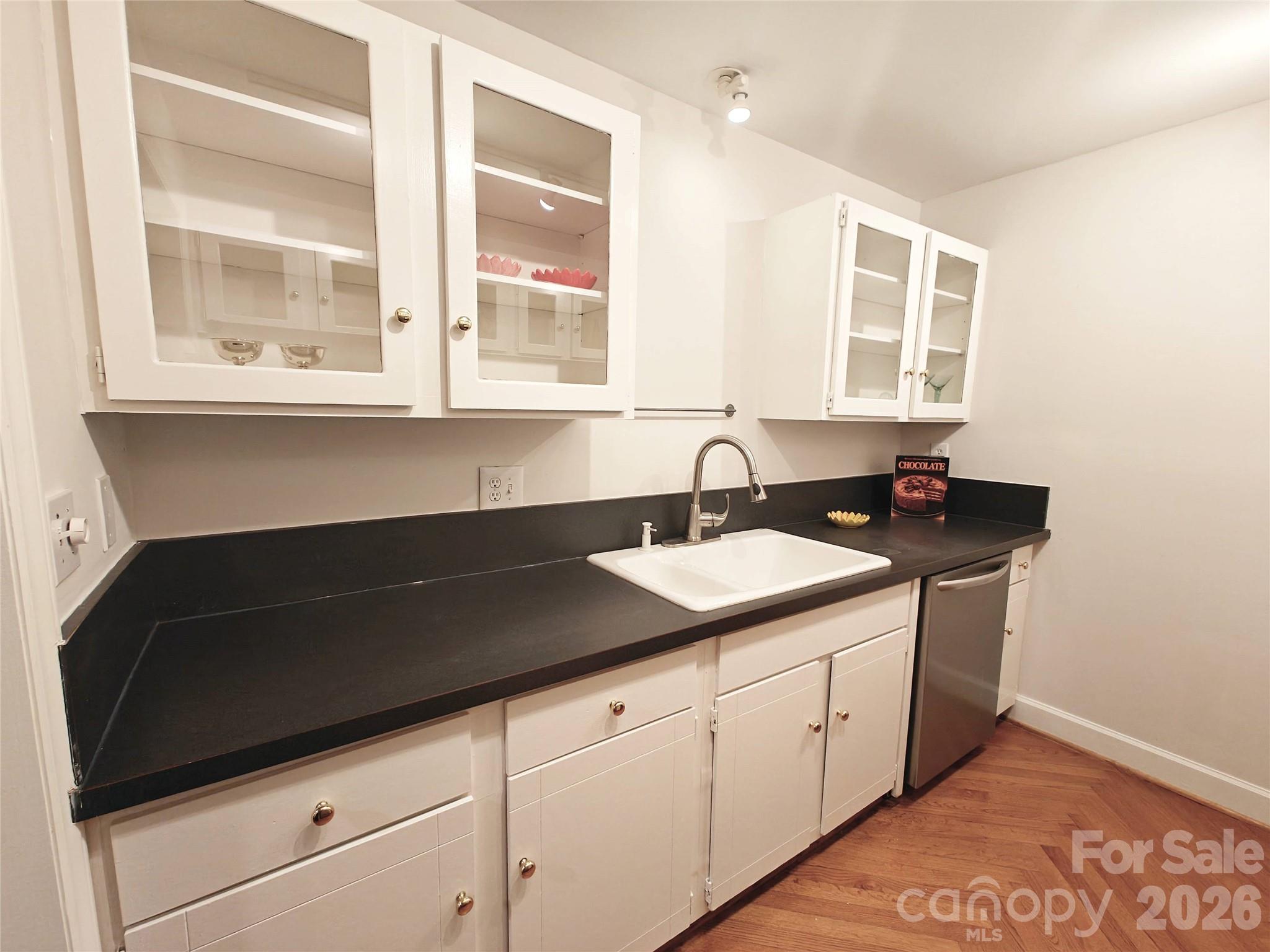 1323 Queens Road, Unit 321 Charlotte, NC 28207 - Photo 7 of 31 a kitchen with a sink and cabinets