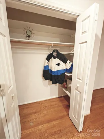 a large white room with a toilet a sink and a mirror