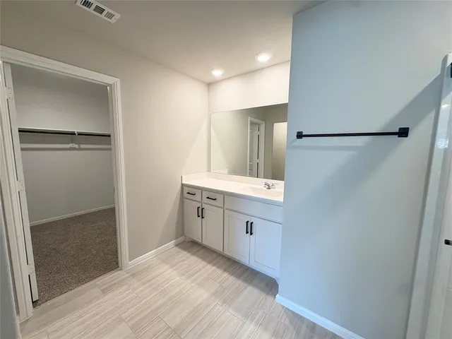 an empty room with windows and ceiling fan