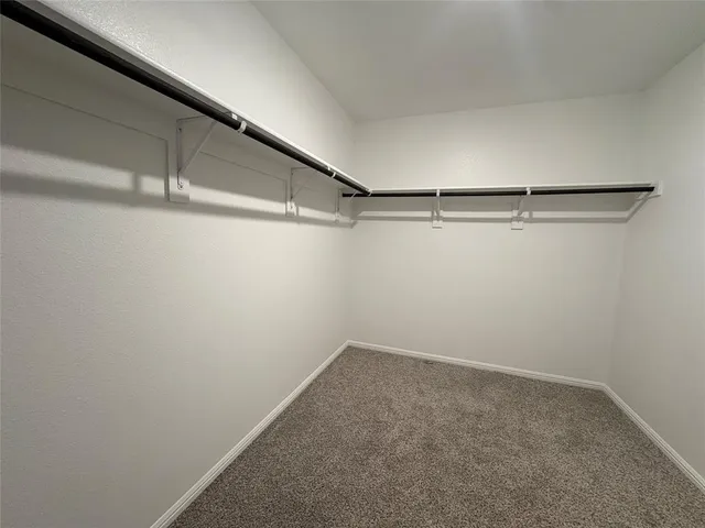 a spacious bathroom with a shower sink and mirror