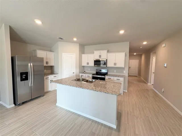 a kitchen with granite countertop kitchen island wooden floors center island and center island
