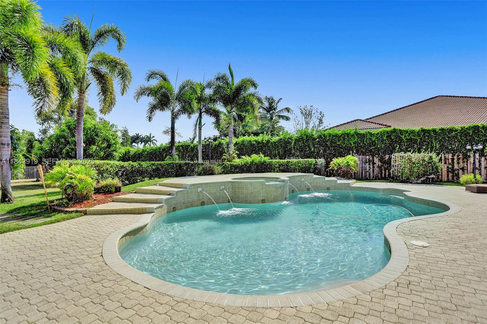 721 Ranch Road Weston, FL 33326 - Photo 10 of 38 a view of a swimming pool with a yard