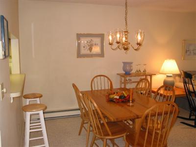 Undisclosed Address Brewster, MA 02631 - Photo 3 of 10 a view of a dining room with furniture and chandelier