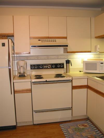 Undisclosed Address Brewster, MA 02631 - Photo 5 of 10 a stove top oven sitting inside of a kitchen