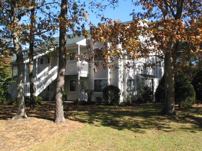 Undisclosed Address Brewster, MA 02631 - Photo 10 of 10 a view of a house with snow on the tree