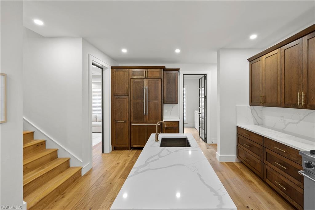 55 Burning Tree Drive Naples, FL 34105 - Photo 14 of 45 a spacious bathroom with a double vanity sink and a large mirror