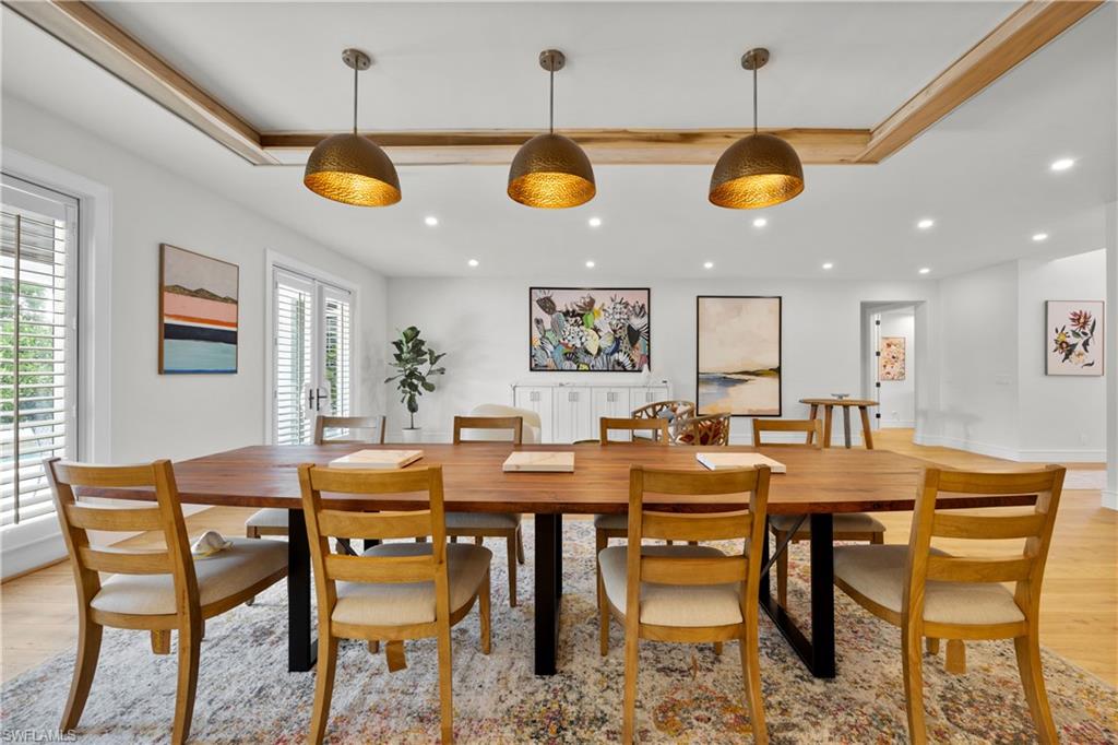 55 Burning Tree Drive Naples, FL 34105 - Photo 18 of 45 a view of a dining room with furniture and chandelier