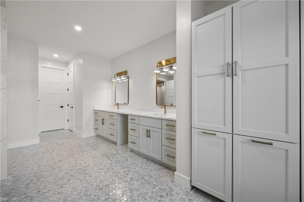 55 Burning Tree Drive Naples, FL 34105 - Photo 22 of 45 a room with a refrigerator and a sink